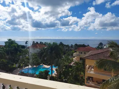 a view of the ocean from the balcony of a resort at Las Palmeras by Graziano in Boca Chica