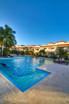 a large swimming pool in front of a building at Las Palmeras by Graziano in Boca Chica