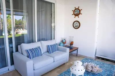 a living room with a couch and a table at Riviera Azul -2 Hab con vista a la Piscina - cash only or paypal in San Felipe de Puerto Plata