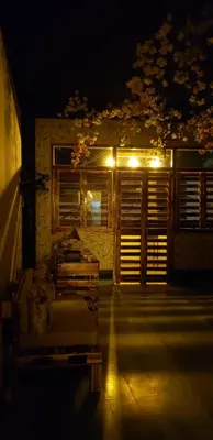 a room with a bed and a window at night at Tus Recuerdos in Santo Domingo