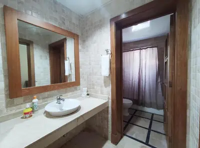 a bathroom with a sink and a mirror and a toilet at BeachFront Apartament - Private Beach Access in Punta Cana