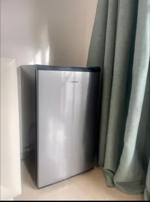 a refrigerator sitting in front of a curtain at Blue Island Punta Rucia in Punta Rucia