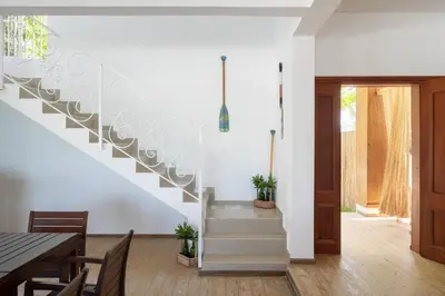 a staircase in a living room with a table and chairs at Blue Island Punta Rucia in Punta Rucia
