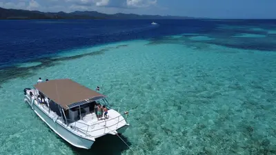 a boat in the water in the ocean at Blue Island Punta Rucia in Punta Rucia