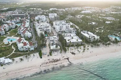 an aerial view of a beach with condos and the ocean at Tropical Deluxe 2 Bedroom Unit with Picuzzi in Punta Cana