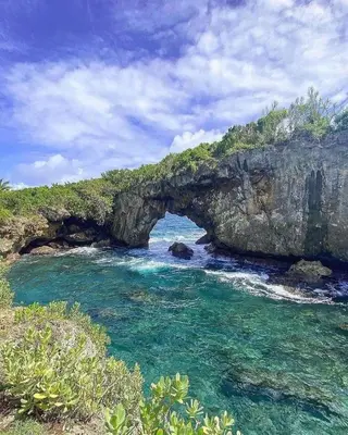 an archway in a cliff over a body of water at Apartamento Piro 1 - 4 pax - a 5 Min De La Playa in Las Galeras