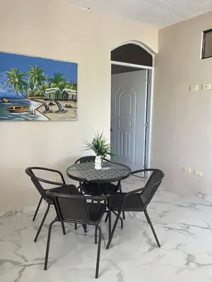 a table and chairs in a room with a painting at Apartamento Piro 1 - 4 pax - a 5 Min De La Playa in Las Galeras