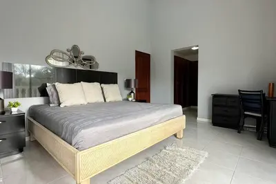 a bedroom with a bed and a table and chairs at Private Getaway - Sosua in Sosúa