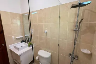 a bathroom with a shower and a toilet and a sink at Private Getaway - Sosua in Sosúa