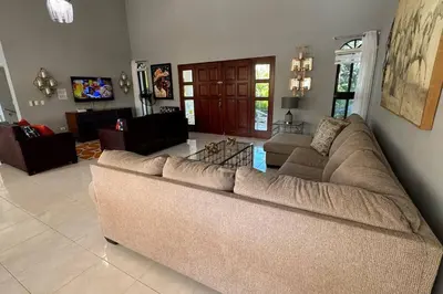 a living room with a large couch in a room at Private Getaway - Sosua in Sosúa