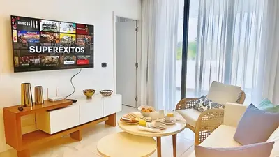 a living room with a couch and a table at Cana Rock Star-Two apartments very close-Ground floor direct access to the pool in Punta Cana