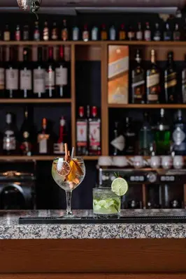 a drink sitting on a counter in a bar at Habana Hotel Y Restaurante in Higuey