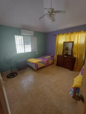 a bedroom with two beds and a ceiling fan at Mangobich in Punta Balandra