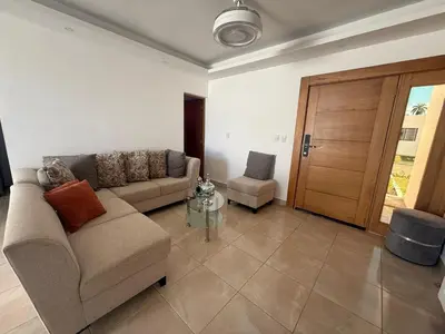 a living room with a couch and a table at villa green paradise in San Felipe de Puerto Plata
