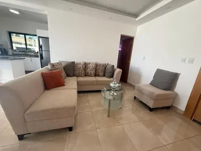 a living room with a couch and a chair at villa green paradise in San Felipe de Puerto Plata