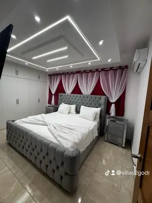 a bedroom with a large bed with red curtains at villa green paradise in San Felipe de Puerto Plata