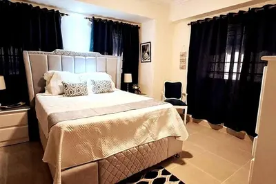 a bedroom with a large bed with black curtains at Goistay Descubre el Encanto nico de Repblica Dominicana Bella Vista in Los Prados