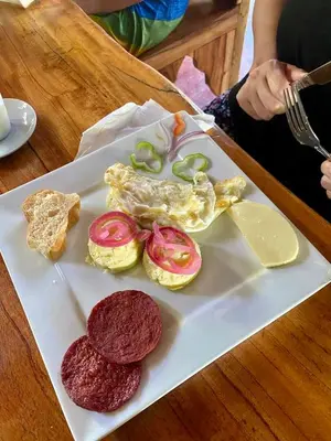 a plate of food with hamburgers and vegetables on it at Rustic House 2 in Punta Rucia