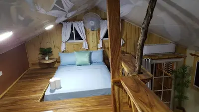 a bedroom with a bed in a room at Rustic House 2 in Punta Rucia