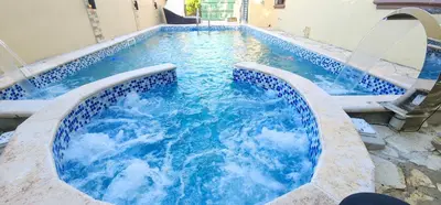 a large swimming pool with blue water in it at Villa lujosa con piscina bayaguana in Bayaguana