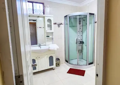 a bathroom with a shower and a sink at Villa lujosa con piscina bayaguana in Bayaguana