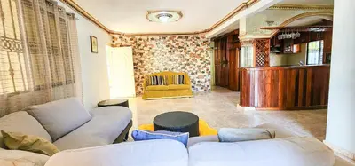 a living room with a couch and a chair at Villa lujosa con piscina bayaguana in Bayaguana
