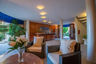 a living room with a table and chairs and a kitchen at Velero Beach Resort in Cabarete