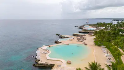 an aerial view of a resort swimming pool and the ocean at TRACADERO Beach Club & Holidays Rentals in Bayahibe