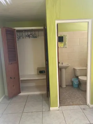 a bathroom with a toilet and a tub and a sink at Coco Hotel and Hostel in Sosúa