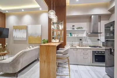 a kitchen with a couch and a table in a room at S802 Lujoso Apartamento Downtown Santo Domingo RD in Santo Domingo