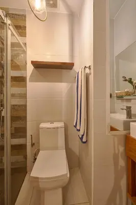 a white bathroom with a toilet and a sink at S802 Lujoso Apartamento Downtown Santo Domingo RD in Santo Domingo