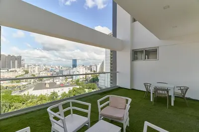 a balcony with a table and chairs and a view at S802 Lujoso Apartamento Downtown Santo Domingo RD in Santo Domingo