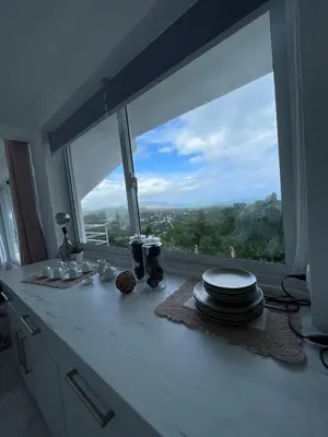 a kitchen counter with a window with plates on it at Apartamento panorámico vista al mar in Las Galeras