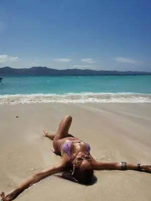 a woman in a bikini laying on a beach at Beach Terrace Loft in Buen Hombre in Buen Hombre