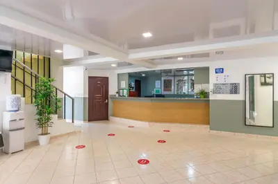 a lobby with a waiting area with red circles on the floor at Hotel Plaza Europa in Sosúa