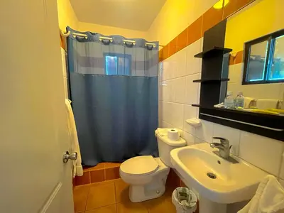 a bathroom with a toilet and a sink at Coral Blanco Hotel in Sosúa