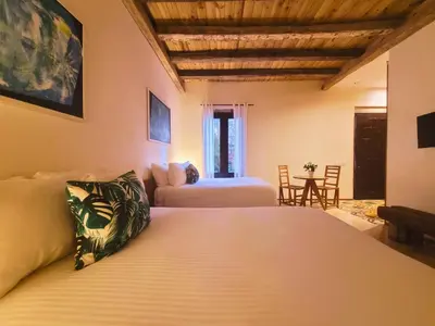 a bedroom with a bed and a living room at Heritage Residences Signature Collection in Santo Domingo