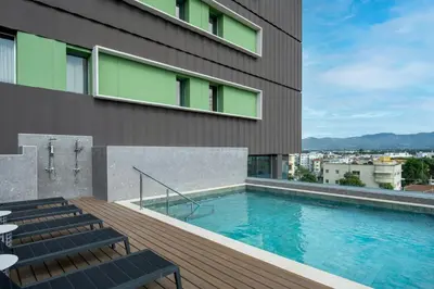 a swimming pool on the side of a building at Residence Inn by Marriott Santiago de los Caballeros in Santiago de los Caballeros