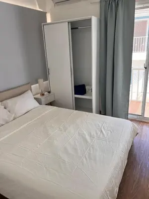 a bedroom with a white bed with a large window at EMY HOUSE in La Laguna
