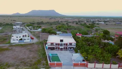 an aerial view of a house with mountains in the background at Hotel Vista al Morro in San Fernando de Monte Cristi