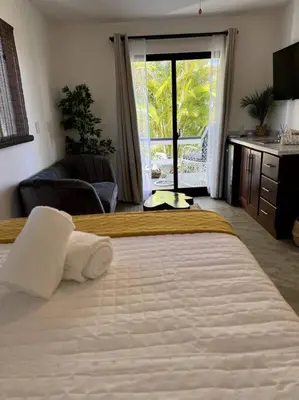a bedroom with two beds and a large window at Catalina, Cabrera Oceanview Multi 2 BD 2 Bath Condo Units with Balcony and Pool in Caño Seco