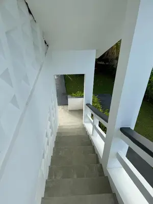 a staircase leading up to a house with white walls at Catalina, Cabrera Oceanview Multi 2 BD 2 Bath Condo Units with Balcony and Pool in Caño Seco