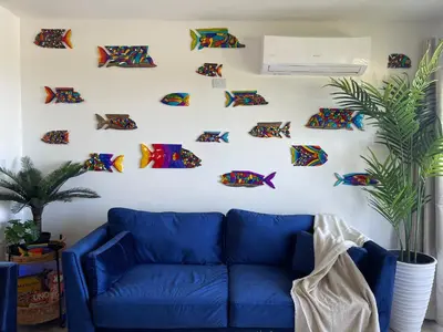 a blue couch against a white wall with fish magnets at Catalina, Cabrera Oceanview Multi 2 BD 2 Bath Condo Units with Balcony and Pool in Caño Seco