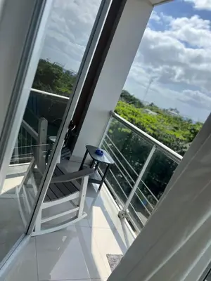 a balcony with a chair and a window at Perfecto para 3 personas. in Boca Chica