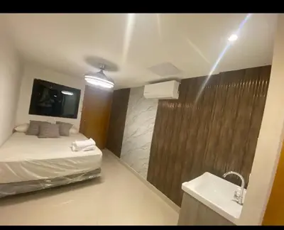 a bathroom with a bed and a shower and a sink at Estudio privado con vigilancia 24/7 con entrada independiente, in Santiago de los Caballeros