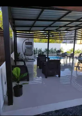 a pergola with a table and chairs on a patio at Estudio privado con vigilancia 24/7 con entrada independiente, in Santiago de los Caballeros