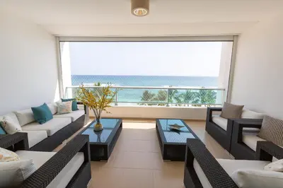 a living room with a view of the ocean at Marbella Juan Dolio Beachfront in Juan Dolio