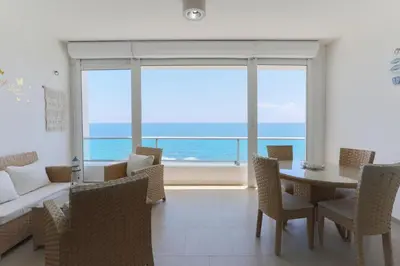 a dining room with a view of the ocean at Marbella Juan Dolio Beachfront in Juan Dolio