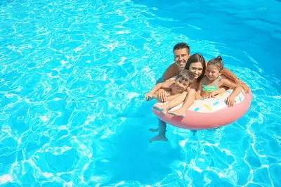 a man and a woman and two children in a pool at Marbella Juan Dolio Beachfront in Juan Dolio
