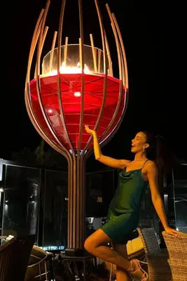 a woman is standing in front of a large lamp at Exclusive Villa * private Beach and Housekeeping in Punta Cana